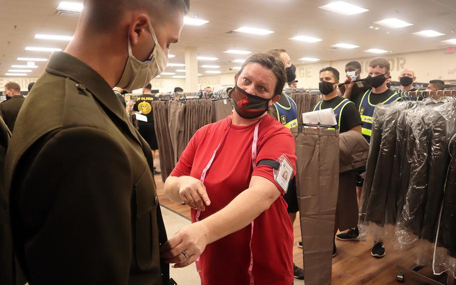 In a Sept. 3, 2020 photo, a drill sergeant gets fitted for an Army Green Service Uniform jacket by a Fort Sill Military Clothing Sales store shift manager. Some 200 new privates nearing the end of basic training at Fort Sill have recently been issued the new uniform, too.
