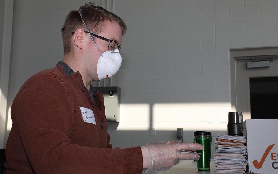 Spc. Brian Olson, a multiple launch rocket system crew member with Battery A, 121st Field Artillery, processes absentee ballots in Fitchburg, Wis., on April 7, 2020.