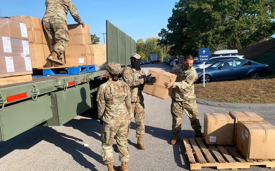 Massachusetts National Guard troops unload personal protective equipment at Marlborough Hospital on Oct. 7. 