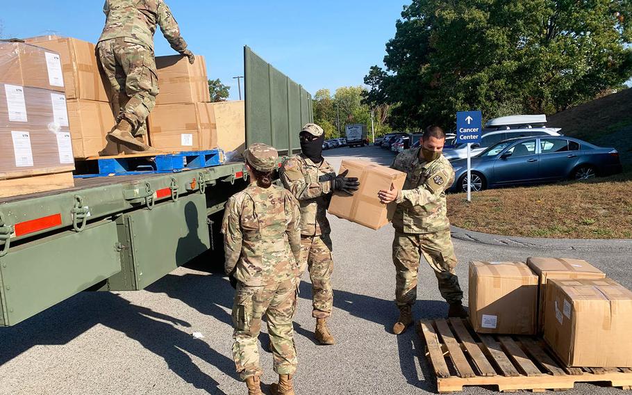 Massachusetts National Guard troops unload personal protective equipment at Marlborough Hospital on Oct. 7.
