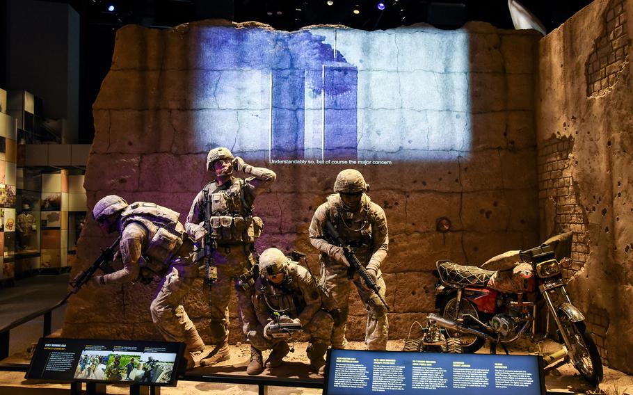 Cast figures depict American soldiers operating in Afghanistan as a video in the background shows news footage of the Sept. 11, 2001 terrorist attacks on the World Trade Center in New York, inside the new National Museum of the United States Army's Changing World Gallery. The gallery shares the Army's story from 1990 until today and feature artifacts from Afghanistan and Iraq. 