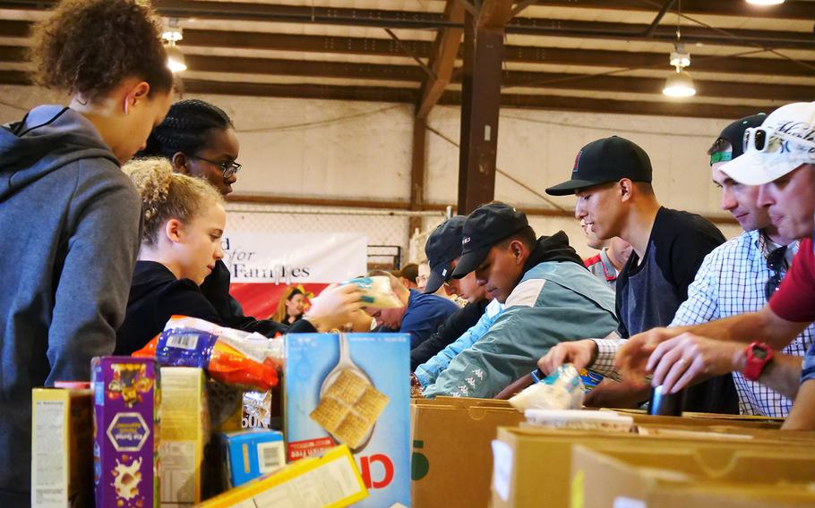 Soldiers from Bravo Co. 1st Battalion, 12th Cavalry Regiment, 3rd Brigade, 1st Cavalry Division collect food items to be boxed for distribution to local food banks during the Central Texas Food for Families food drive, November 16, 2020. The one-day drive collected over two million pounds of food for 20 food banks in nine counties.