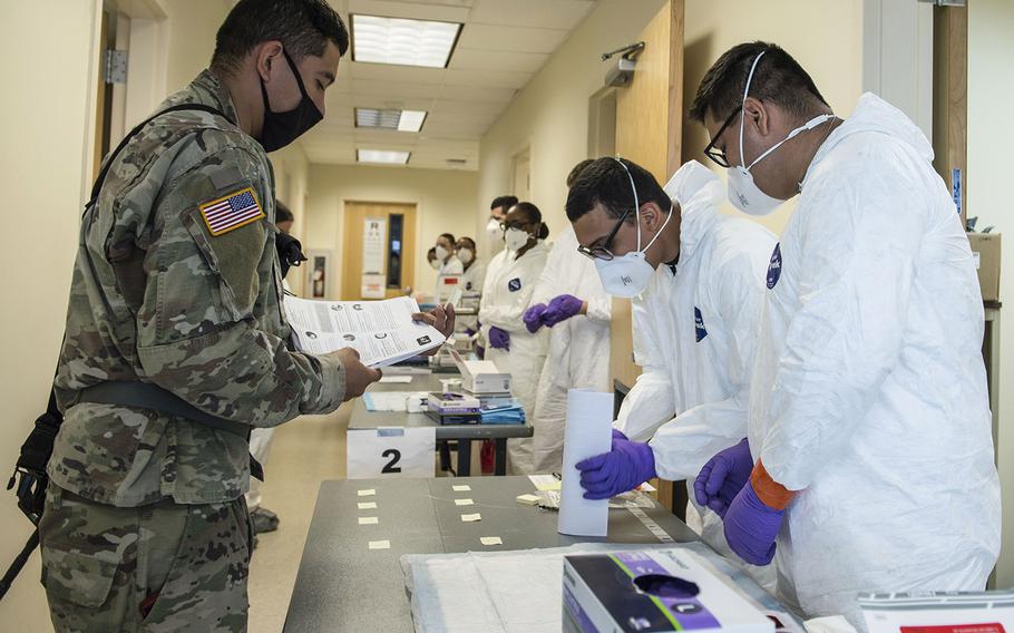 In a June 9, 2020 photo, soldiers attached to the Texas Army National Guard's 36th Infantry Division and 272th Engineer Company receive an COVID-19 IgG, IgM antigen test at Camp Swift in Bastrop, Texas. 
