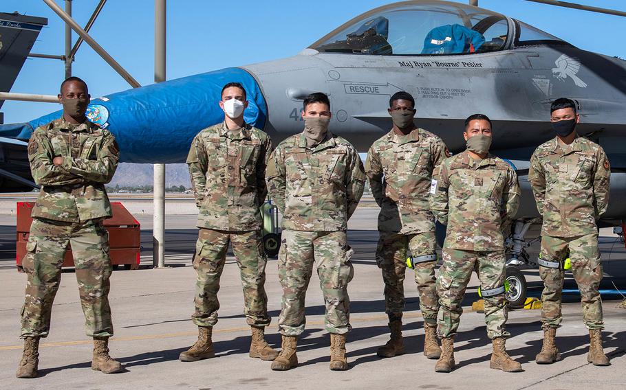 Staff Sgt. Darion Hubbard, left) 372nd Training Squadron F-16 Fighting Falcon crew chief instructor, poses for a photo with his F-16 Right Time Training class, Nov. 17, 2020, at Luke Air Force Base, Ariz. The RTT class is a new initiative to provide small-group, instructor-led, hands-on training for F-16 crew chiefs after they compete technical training.