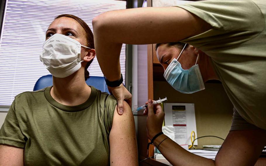 Senior Airman Ava Di Benedetto administers an influenza vaccination to an airman at the Pittsburgh International Airport Air Reserve Station, Pennsylvania. Military health care workers and then first responders will be the first to be vaccinated by the Defense Department when the coronavirus vaccines are approved, according to the Navy’s top officer.