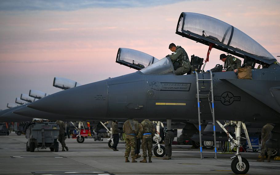 A pilot assigned to the 492nd Fighter Squadron, steps into the cockpit of an F-15E Strike Eagle to prepare for taxiing at Royal Air Force Lakenheath, England, Dec. 2, 2020.