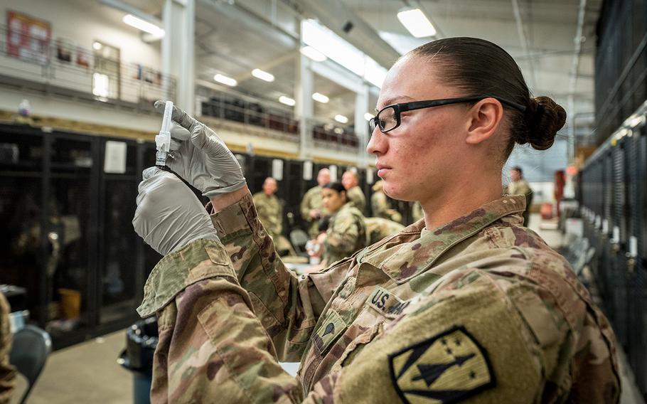 Spc. Selena M. Castillo prepares to administer a flu vaccination on Fort Sill, Okla., Nov. 15, 2019.  Spc. Castillo is a medic for 3rd Battalion, 2nd Air Defense Artillery Regiment, 31st Air Defense Artillery Brigade.