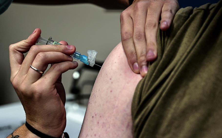 Senior Airman Ava Di Benedetto, 911th Aeromedical Staging Squadron aeromedical technician, administers an influenza vaccination to an airman assigned to 911th Airlift Wing at the Pittsburgh International Airport Air Reserve Station, Pa., Nov. 5, 2020.