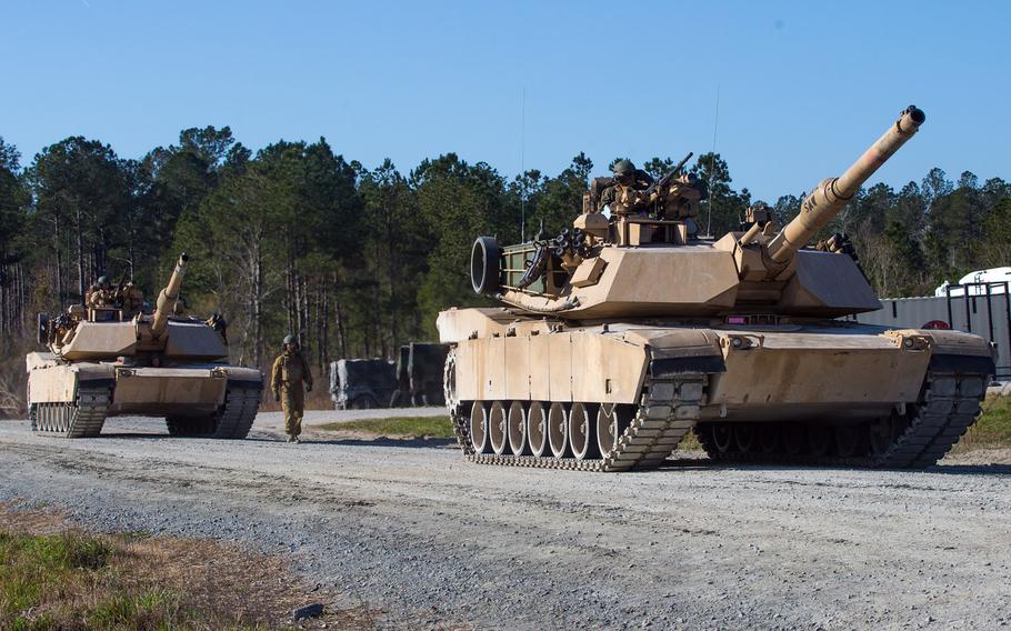 Marine Corps M1A1 Abrams tanks with 2nd Tank Battalion, 2nd Marine Division enter the firing range at Camp Lejeune, N.C., March 11, 2020. Marines in tank-related fields could qualify to leave the service up to one year early under as the service divests itself of heavy armor, in favor of a lighter force.

