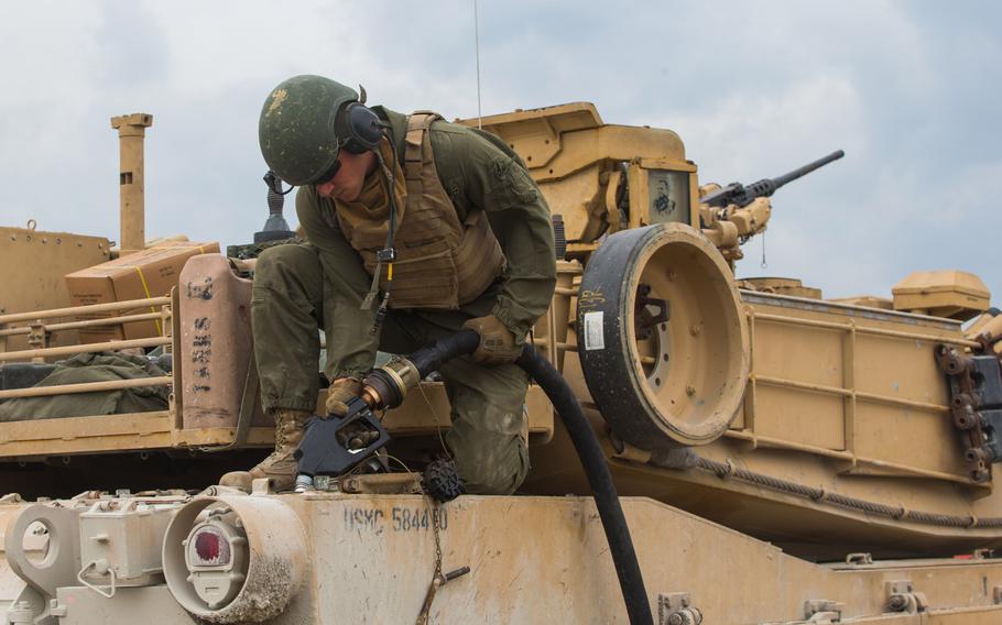 Marine Corps Pfc. Jackson Blackburn, a tank crewman with 2nd Tank Battalion, 2nd Marine Division, refuels an M1A1 Abrams tank at Camp Lejeune, N.C., March 10, 2020. Marines in tank-related fields could qualify to leave the service up to one year early as the Corps sheds its heavy armor to reshape its forces.

