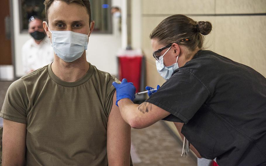 Airman 1st Class Kimber Bernau, 59th Medical Wing Family Emergency Clinic medical technician, administers the San Antonio Military Health System's first Pfizer COVID-19 vaccine shot to Maj. Andrew Gausepohl, Dec. 14, 2020, at Wilford Hall Ambulatory Surgical Center, Joint Base San Antonio-Lackland, Texas.