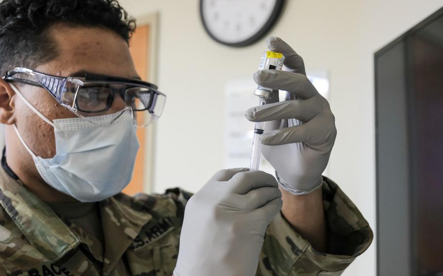 Sgt. Skylar Bacote prepares a dose of the Moderna COVID-19 vaccine at Camp Humphreys, South Korea, Tuesday, Dec. 29, 2020.

