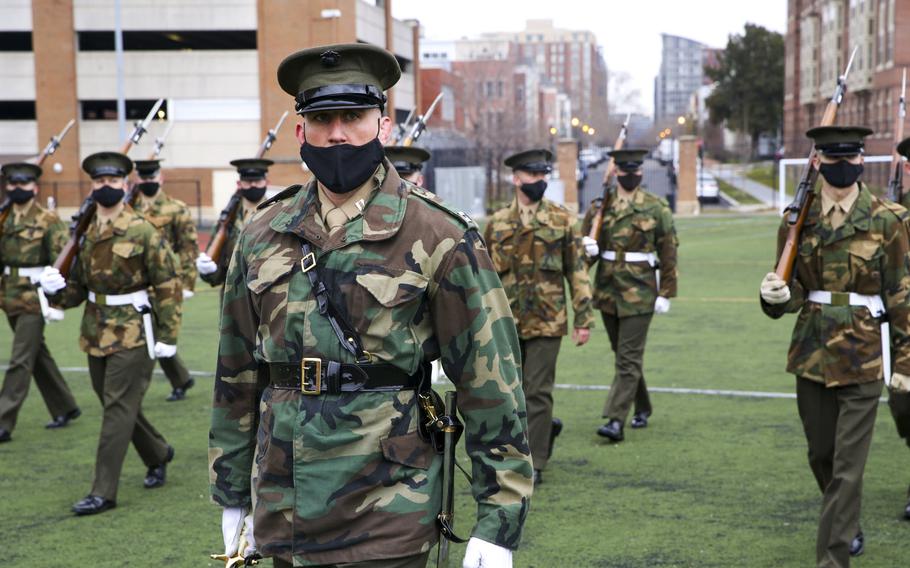 Marines with Marine Barracks Washington prepare for the upcoming Presidential Inauguration, Washington, D.C., Jan. 5, 2021. The Marines are wearing an unusual combination of a Vietnam-era field jacket in woodland camouflage with their khaki-and-olive green service dress uniforms.

