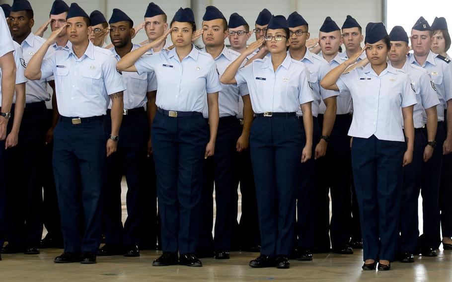 Airmen salute during a ceremony at Ramstein Air Base, Germany. The Air Force has directed commanders to begin collecting airmen’s ranks, age, gender, race and ethnicity when meting out discipline such as letters of reprimand to determine if discipline is being meted out impartially, it announced in January 2021.