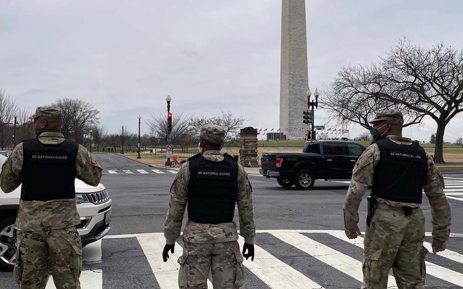In a January 5, 2021 photo, DC National Guard members stand in front of the Washington Monument. The District of Columbia National Guard activated several hundred personnel to support the city government during expected demonstrations.