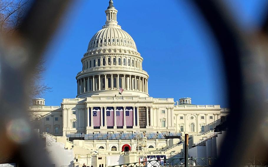 The U.S. Capitol is seen through a security fence on Jan. 12, 2021.