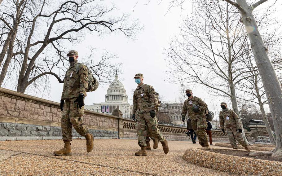 U.S. Soldiers with the New Jersey National Guard patrol the area near the Capitol building in Washington, D.C., Jan 11, 2021. A memo, sent to the entire military and signed by all eight members of Joint Chiefs of Staff reiterates to the force that the U.S. military will obey lawful orders from civilian leadership and “remains fully committed” to protecting and defending the Constitution.