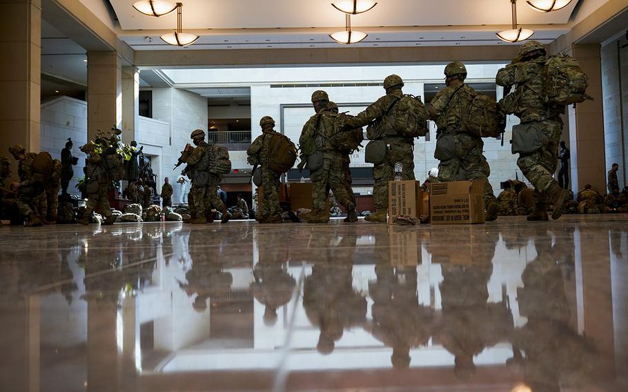 Troops move inside the Capitol Visitor Center to reinforce security at the Capitol in Washington, Wednesday, Jan. 13, 2021. 