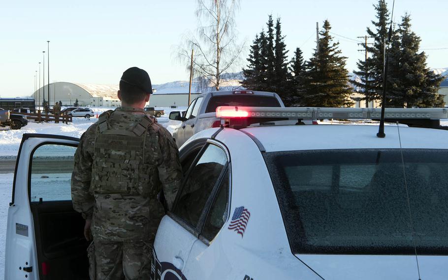 A member of security forces at Joint Base Elmendorf-Richardson, Alaska, simulates pulling over an alcohol-impaired driver, Jan. 15, 2019. 