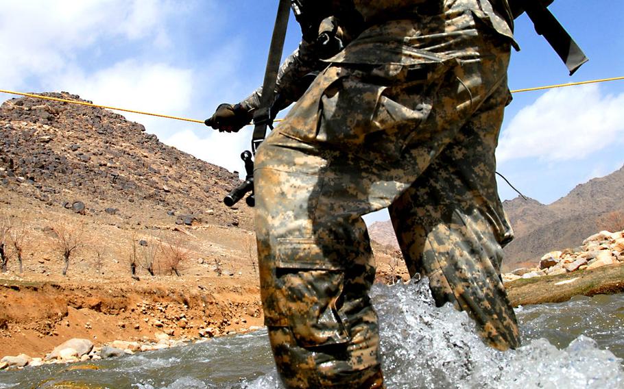 U.S. Army Spc. Nick Giovannelli from Bravo Company, 1st Battalion, 4th Infantry Regiment, fights the current as he crosses a river while on a dismount patrol mission near Forward Operation Base Baylough, Zabul Province, Afghanistan, on March 17, 2009. Giovanelli is suing to prevent retailers from selling Defense Department-released images of him.


