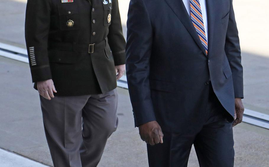 Defense Secretary Lloyd Austin walks up to the Pentagon accompanied by Army Gen. Mark Milley, chairman of the Joint Chiefs of Staff, shortly after being confirmed by the Senate Jan. 22, 2021. He was sworn in as the 28th defense secretary shortly afterward.(Photo by ) 