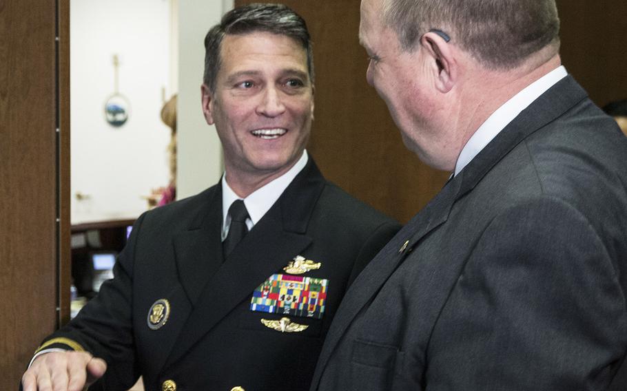 Rear Adm. Ronny Jackson, President Donald Trump's nominee to succeed David Shulkin as Secretary of Veterans Affairs, talks with Senate Veterans' Affairs Committee Ranking Member Jon Tester, D-Mont., in Tester's Capitol Hill office, April 17, 2018.