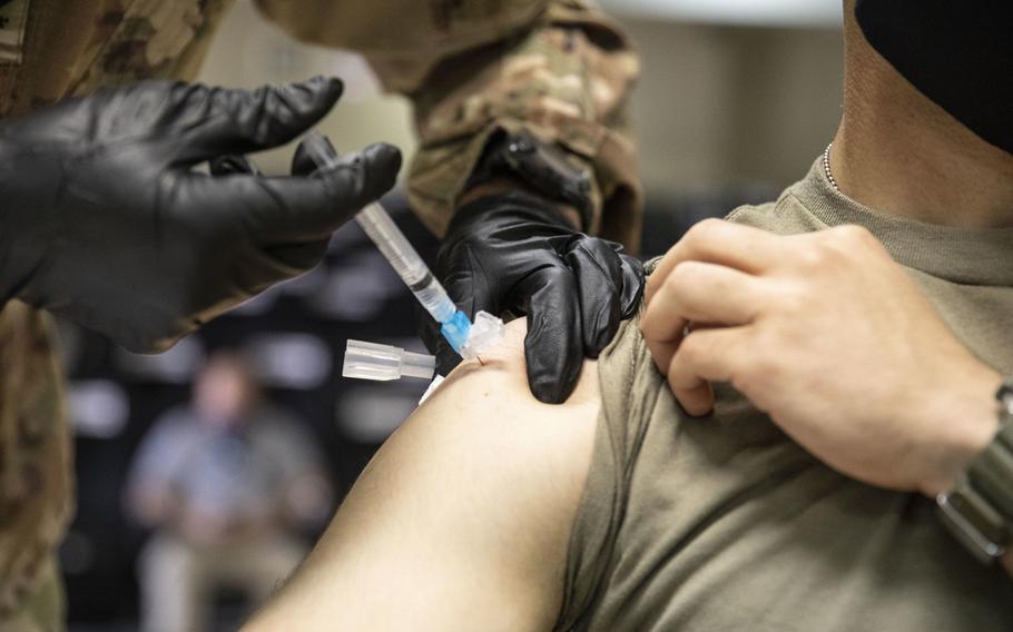 A soldier gets a flu shot in October 2020 on Camp Arifjan, Kuwait. A contractor and a soldier were each infected with COVID-19 and seasonal influenza at the same time in the Central Command area of responsibility, a military medical report in December said.
