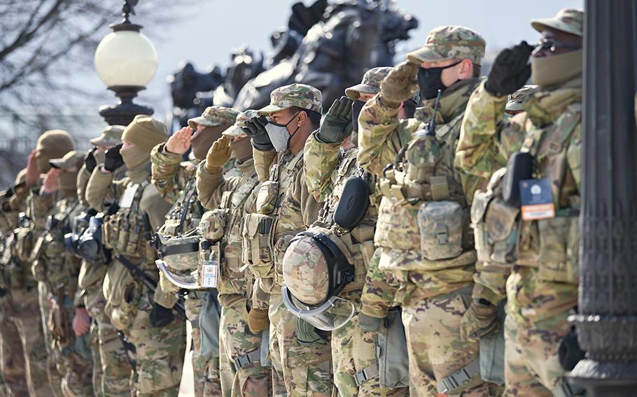 Members of the National Guard salute during the presidential inauguration ceremony in Washington D.C., on Jan. 20, 2021. At least 25,000 Guard members were authorized to conduct security, communication and logistical missions leading up and through the 59th Presidential Inauguration.