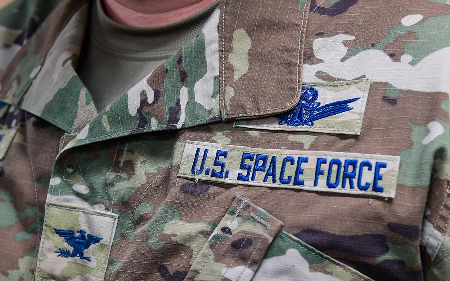 A Space Force officer poses for a detailed photo of his new patches after commissioning into the USSF on Buckley Air Force Base, Colo., Jan. 5, 2021.