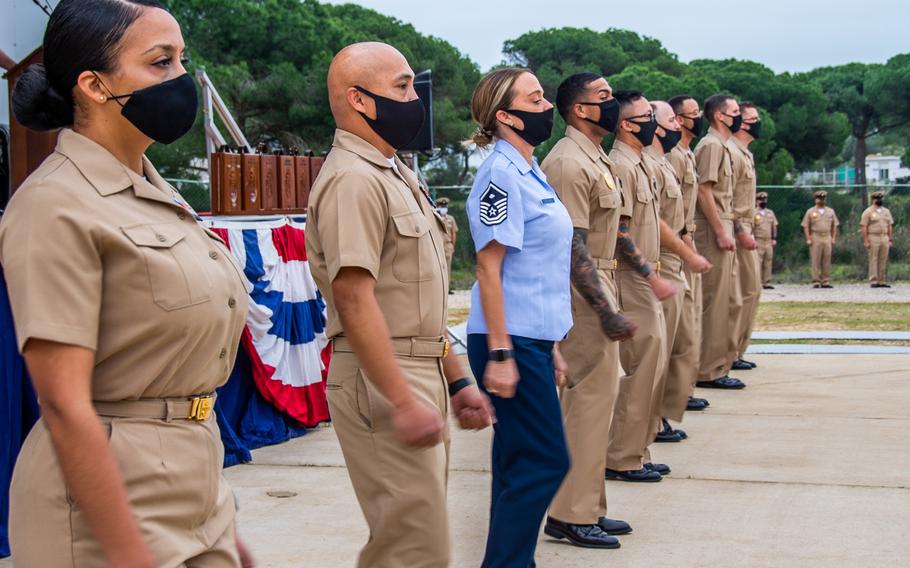 Service members selected for promotion to chief petty officer arrive in formation during a promotion ceremony at Naval Station Rota, Spain, Jan. 29, 2021. 