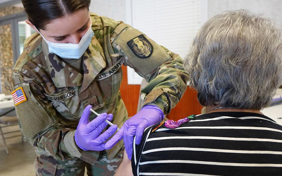 A Texas National Guard medic administers coronavirus vaccine on Jan.29, 2021, in Cuero, Texas. On Friday, Defense Secretary Lloyd Austin announced that more than 1,000 active-duty troops will join the vaccination efforts at multiple locations throughout the U.S.