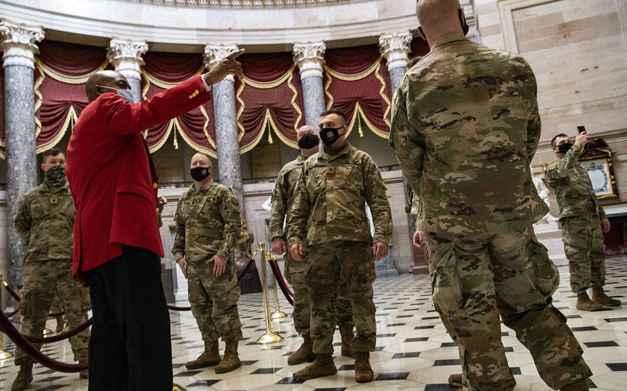 Off-duty National Guard troops learn about the history of the U.S. Capitol in the building's rotunda on Feb. 4, 2021.