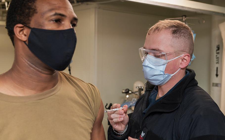 In a January 11, 2021 photo, a sailor on board the amphibious transport dock ship USS San Antonio receives the coronavirus vaccine.