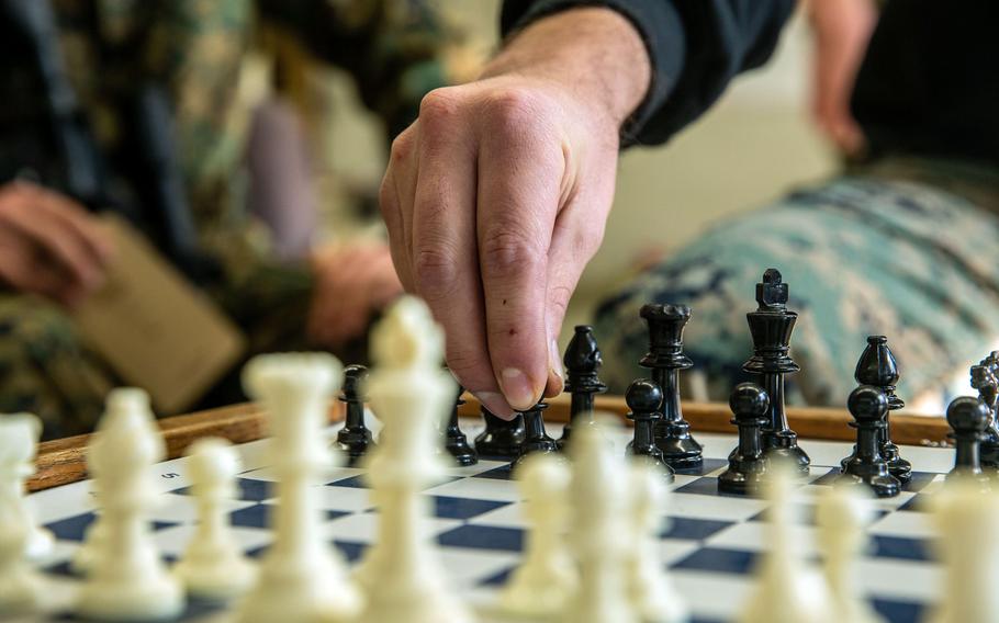Marine Sgt. Alec Escalante, a squad instructor with Alpha Company, Infantry Training Battalion, School of Infantry-West, moves a chess piece during a class on how chess correlates with battle tactics, as part of the first week of the Infantry Marine Course at SOI-West on Marine Corps Base Camp Pendleton, Calif., Jan. 27, 2021. 

