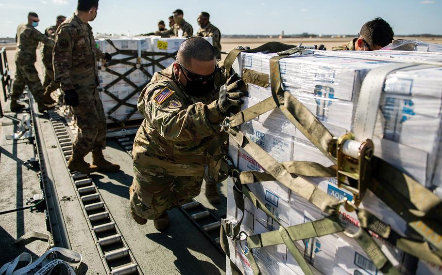 Airmen and soldiers unload pallets of bottled water Feb. 21 at Joint Base San Antonio-Kelly Field in Texas. Joint Base San Antonio provided emergency response assistance to local officials and agencies in order to ensure the safety and security of the community during and after the severe winter storm.