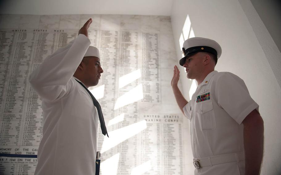 A sailor assigned to the guided-missile cruiser USS Mobile Bay recites the oath of enlistment inside the USS Arizona Memorial at Pearl Harbor, Hawaii, April 24, 2013. 