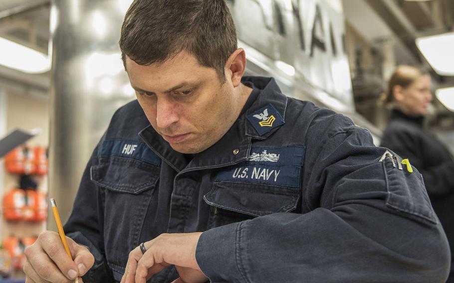 In a Jan. 19, 2017 photo, Hull Maintenance Technician 1st Class Justin Huf takes the chief petty officer exam aboard the Arleigh Burke-class guided-missile destroyer USS Mahan. The Navy said Huf died of the coronavirus at Norfolk’s Sentara Leigh Hospital on Feb. 22, 2021.