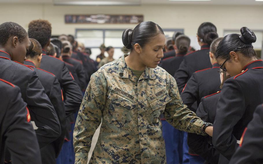 Sgt. Cristal Abregomedina examines the uniforms of Marines from the 4th Recruit Training Battalion in 2018 at Parris Island, S.C. Women in the military pay more out-of-pocket costs for uniform items than men, the Government Accountability Office found after Congress ordered a review. 

