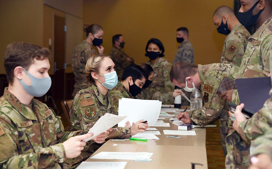 In a Feb. 16, 2021 photo at Keesler Air Force Base, Miss., airmen from the 81st Force Support Squadron verify the credentials of 81st Medical Group airmen preparing to deploy to support the nation's COVID-19 vaccine inoculation requirements.