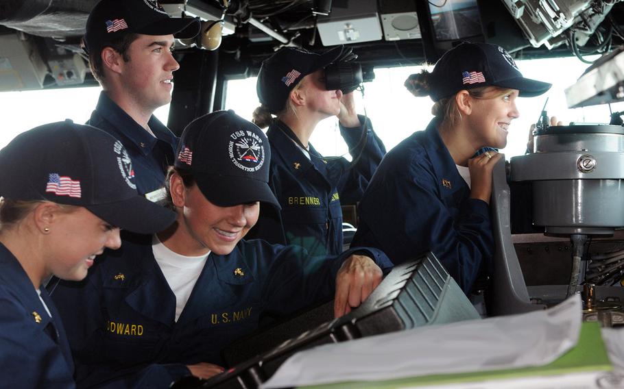In a May, 2010 photo, visiting midshipmen interact with each other following watch station training on USS Wasp's navigation bridge. The U.S. Naval Academy and Navy ROTC send large groups of their students to the fleet each summer to gain practical knowledge of Navy life.