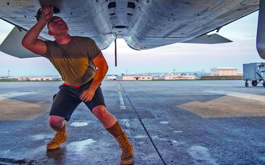 Airman 1st Class Richard Flagg, 67th Aircraft Maintenance Unit crew chief, checks out an F-15C Eagle at Kadena Air Base, Okinawa, Jan. 23, 2020.