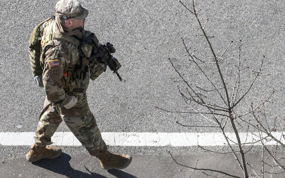 A National Guard soldier, seen from atop a nearby building as he walks down Constitution Ave. in Washington, D.C., March 3, 2021.