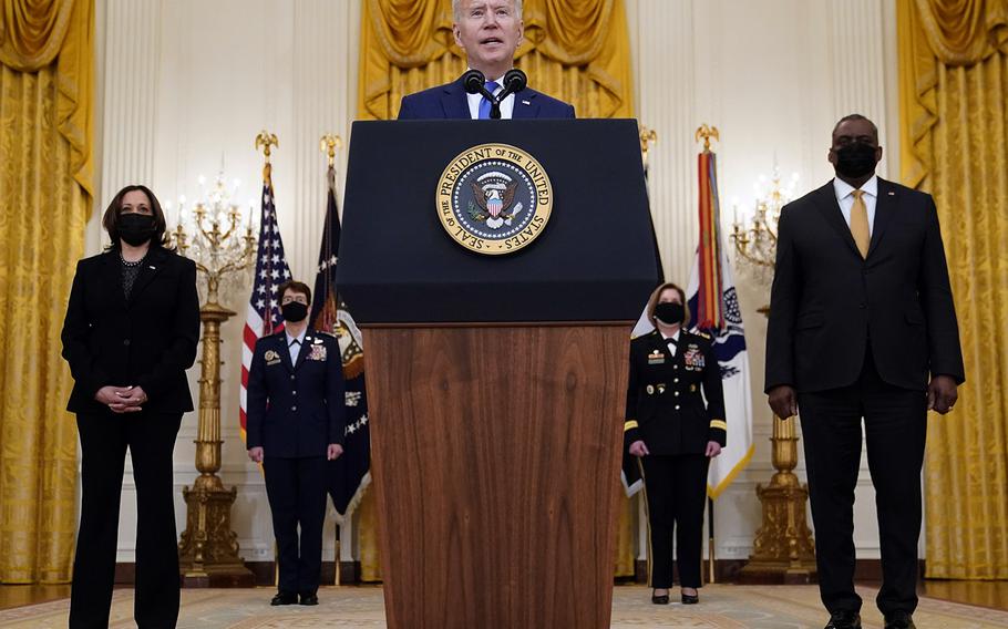 President Joe Biden speaks during an event to mark International Women's Day, Monday, March 8, 2021, at the White House as Vice President Kamala Harris and Defense Secretary Lloyd Austin listen. Behind them are U.S. Air Force Gen. Jacqueline D. Van Ovost and U.S. Army Lt. Gen. Laura J. Richardson.