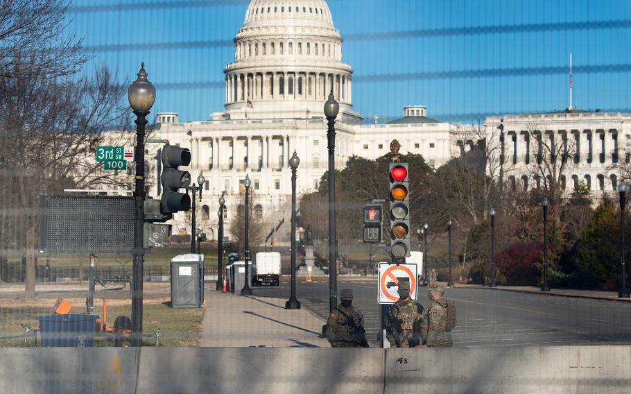 Members of the National Guard patrol inside the fenced-in grounds of the U.S. Capitol in Washington on Feb. 25, 2021. Defense officials said on Tuesday, March 9, that the Pentagon was set to approve an extension of the National Guard deployment at the U.S. Capitol for about two more months.