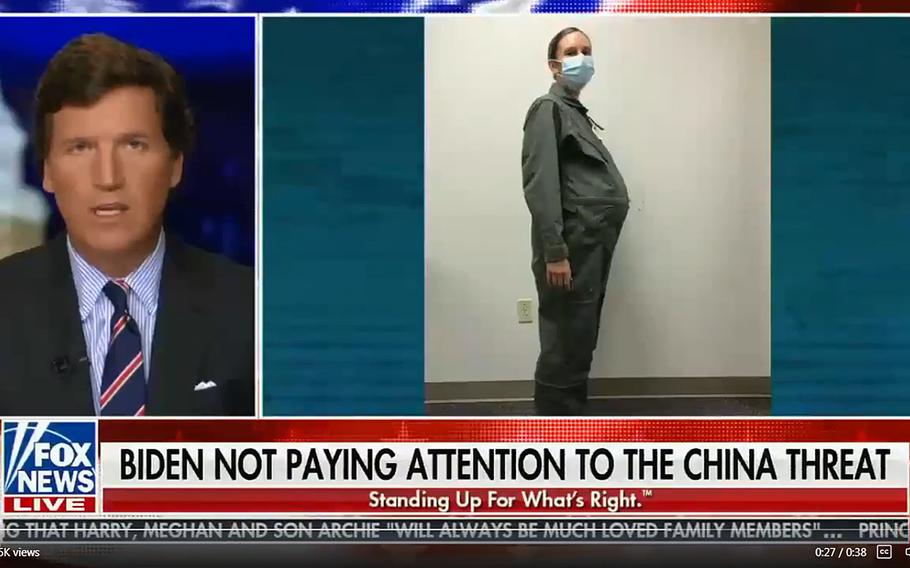 A screenshot from Tucker Carlson's Fox News broadcast from March 10, 2021. During the broadcast, Carlson said pregnant women were going to fight the U.S.'s wars, which made a mockery of the military. The photo is of 1st Lt. Avery Thomson, a program manager for maternity development efforts in the Air Force Uniform Office, modeling a maternity uniform while wearing an artificial pregnancy bump.
