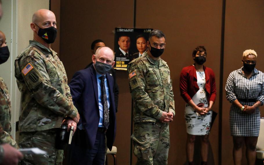 From left, Command Sgt. Maj. Michael Williams, senior enlisted leader of the 1st Armored Division and Fort Bliss, Texas, acting Army Secretary John Whitley and Maj. Gen. Sean Bernabe, commander of the 1st Armored Division and Fort Bliss, view information booths set up March 11 during the Ironclad Summit, a day-long conference designed to inspire ideas on how to prevent and respond to sexual harassment and assault, suicide and extremism.