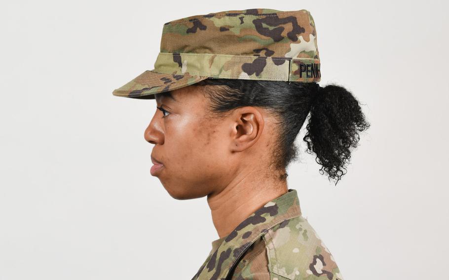 A soldier poses for a photo with medium-length hair secured into a ponytail, as authorized in Army grooming standards in January 2021. Sgt. Maj. of the Army Michael Grinston tweeted recently that long ponytails will be allowed with all uniforms. Currently, they are allowed only during physical training or with the Army Combat Uniform.

