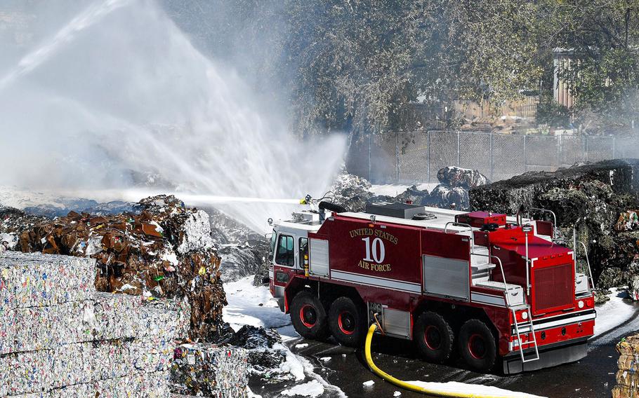 Kirtland Air Force Base firefighters spray foam to tamp down a recycling plant fire in Albuquerque, NM, on Sept. 29, 2020.