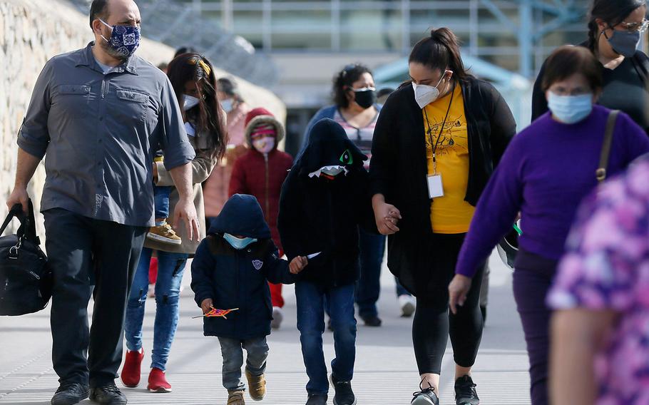 Linda Rivas, executive director of Las Americas Immigrant Advocacy Center, escorts children across the Paso Del Norte bridge as part of 25 migrants who are seeking asylum in the U.S. Friday, February 26, 2021, in El Paso, Texas.