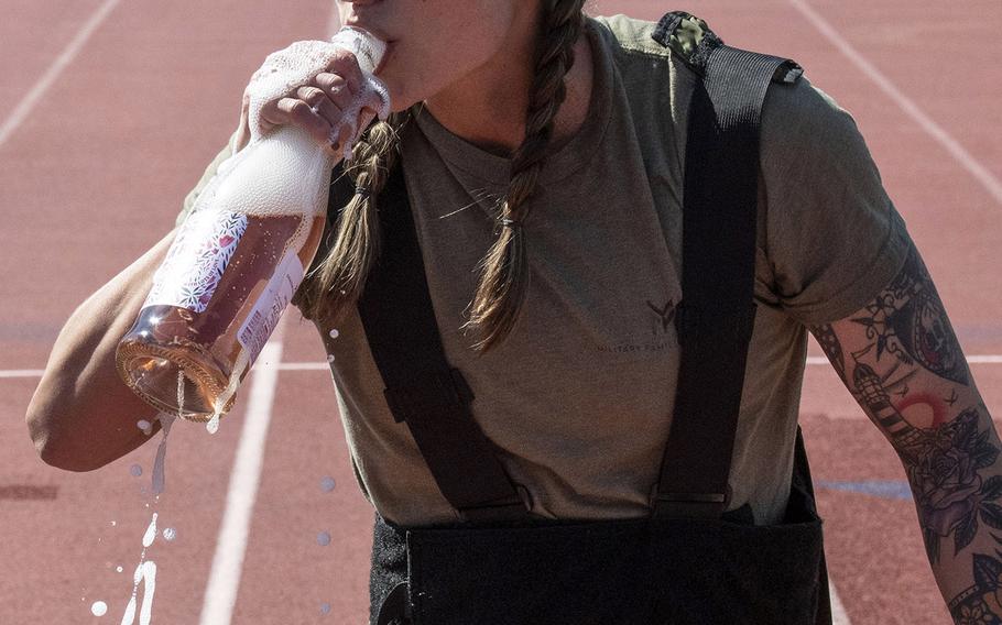 Army Capt. Katie Hernandez celebrates after setting a world women's record for a mile run in a bomb disposal suit, Saturday, April 3, 2021, at George Mason University in Fairfax, Va.